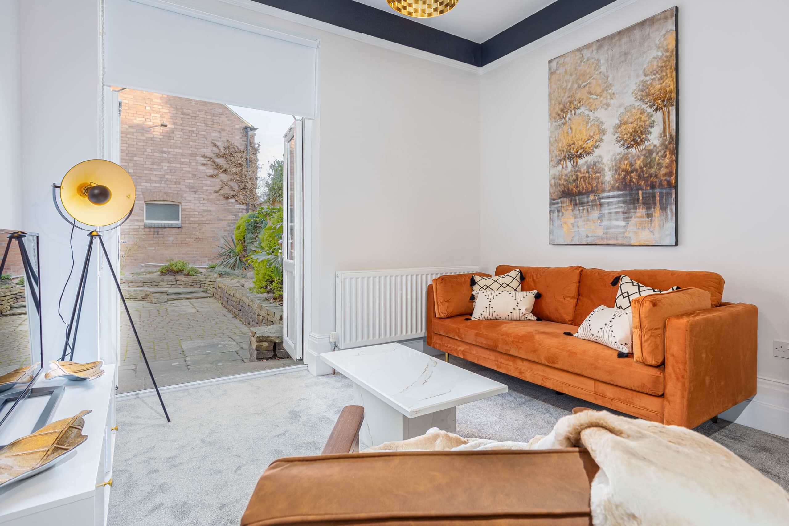 Fully furnished living room with access to private outdoor space