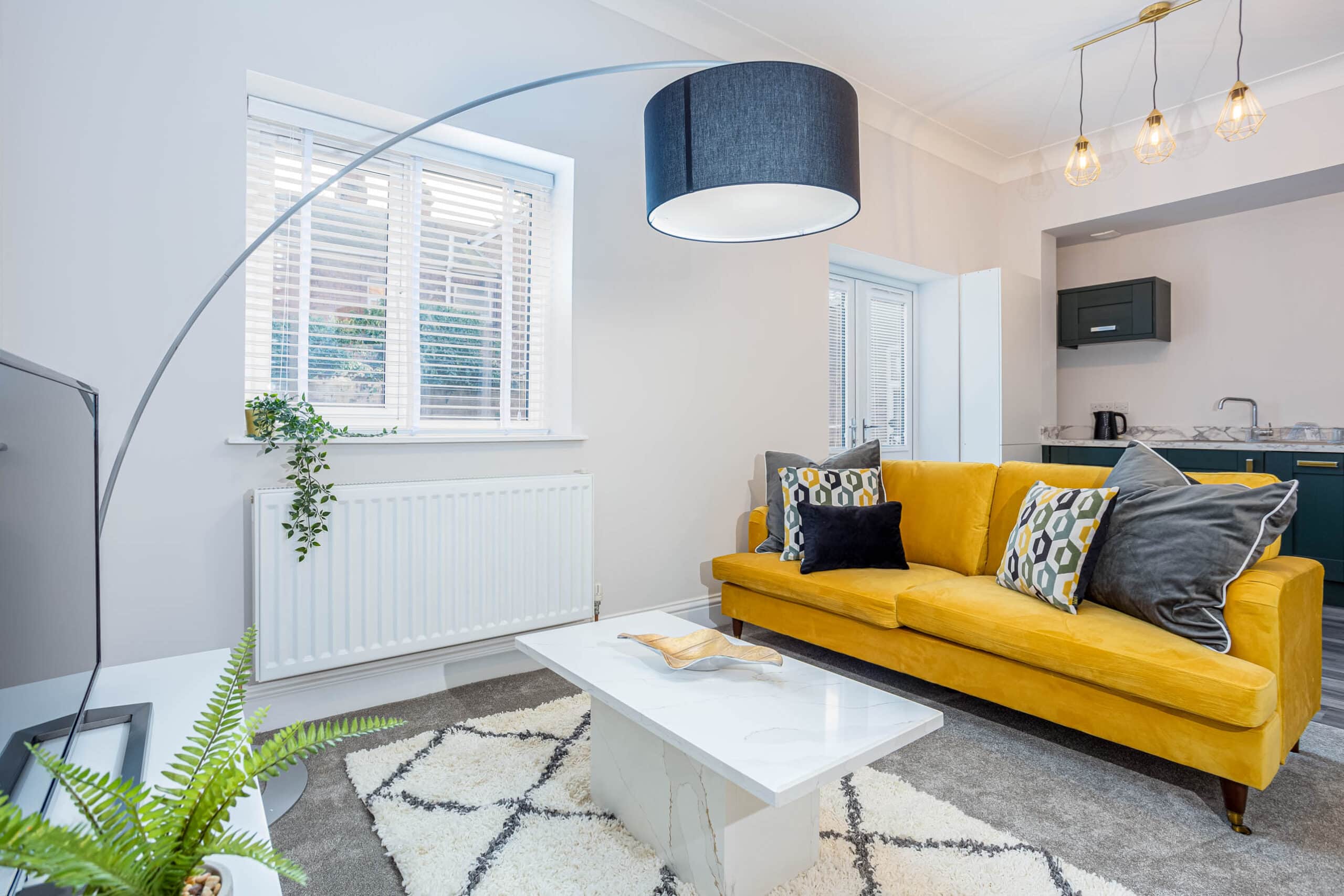 Open living space fully furnished with a large sofa and coffee table in this 2 bedroom apartment in Grimsby for corporate work trips long and short stays available