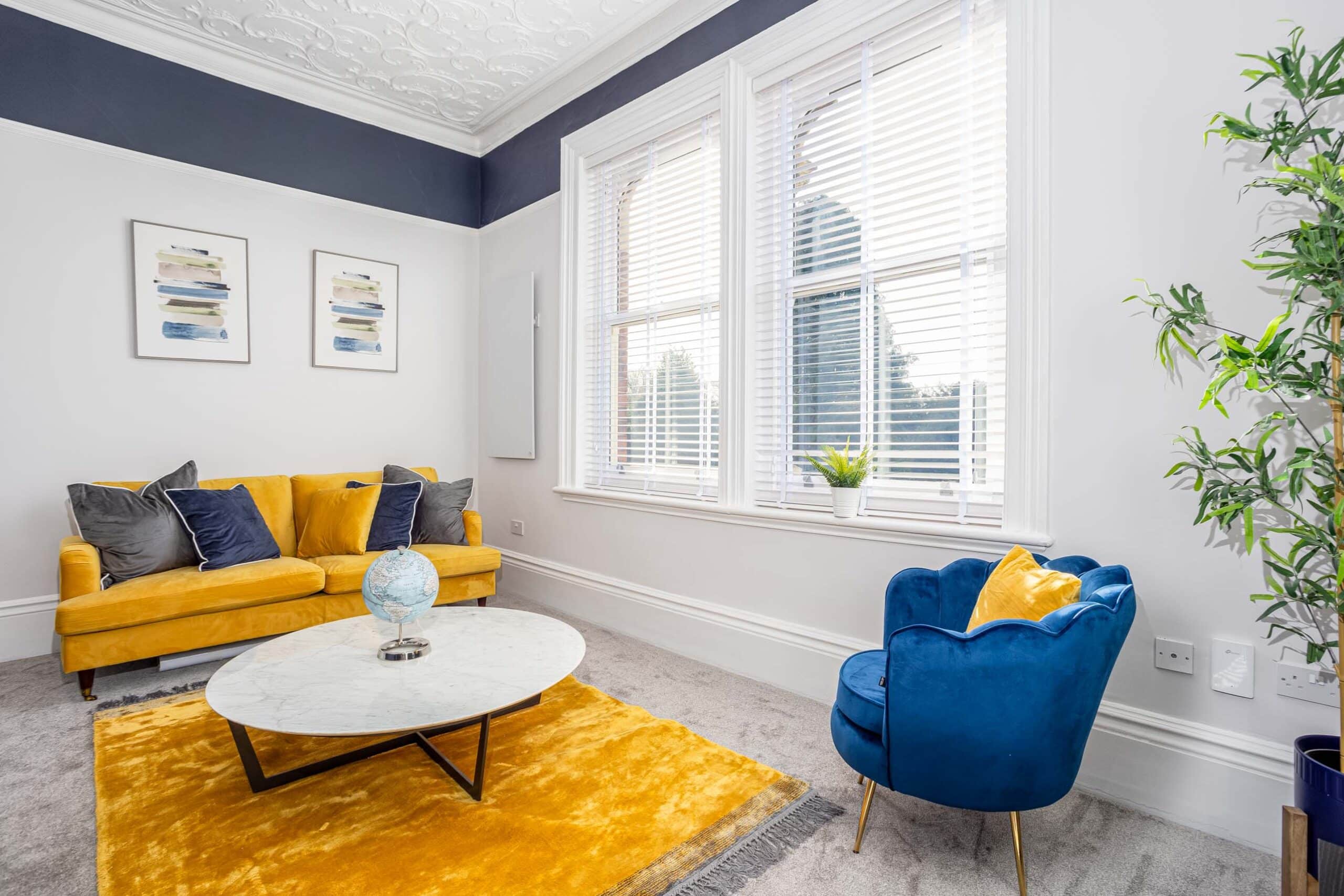 Fully furnished living room with large windows, corporate rentals in Grimsby