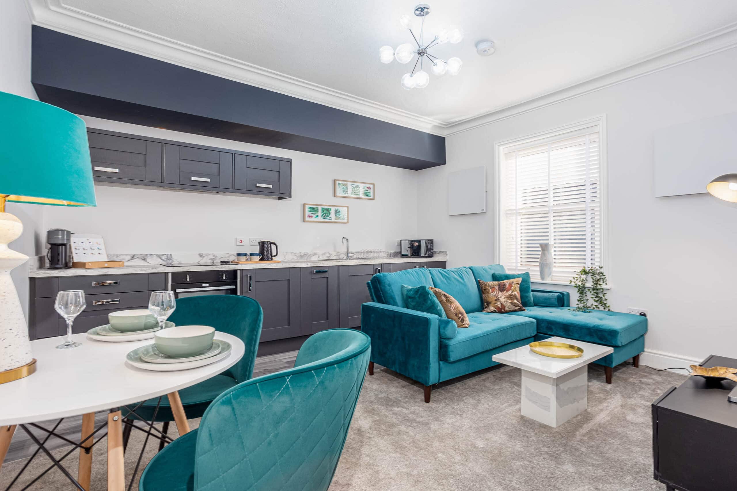 Serviced Accommodation in Grimsby fully furnished with sofa, dining table and chairs and a fully equipped kitchen